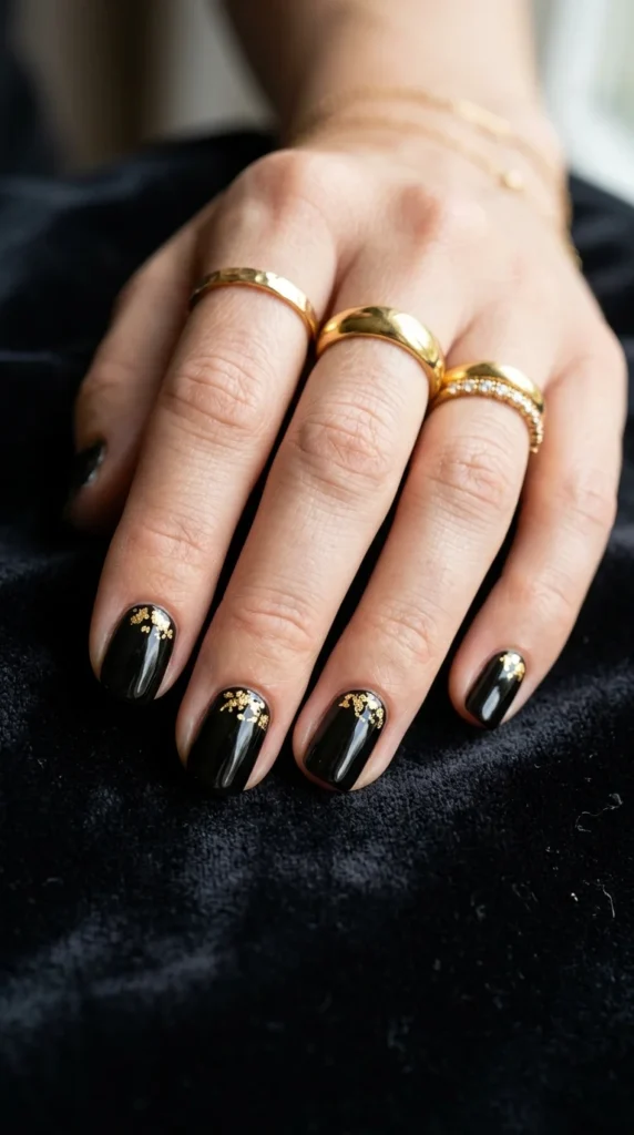 5. Glossy Black Nails with Micro Gold Foil.webp