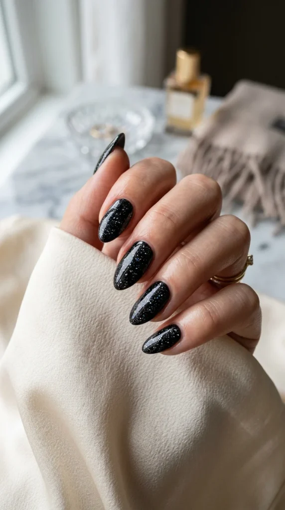 10. Glossy Black Nails with Micro Glitter.webp