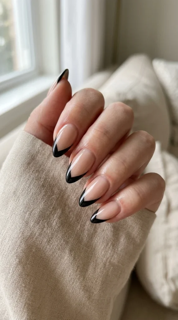 6. Black V-Cut French Tips for a Modern Edge.webp